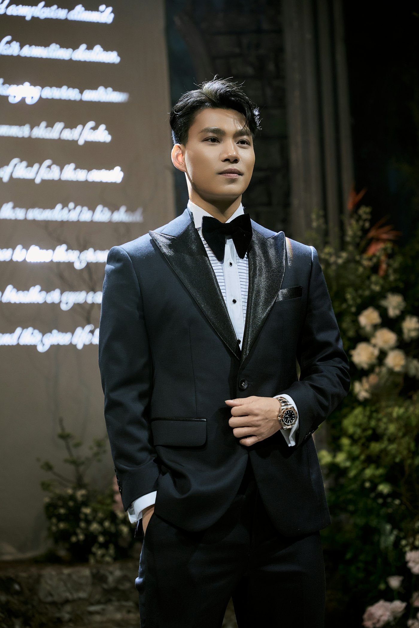 Man wearing a black dinner suit and bow tie